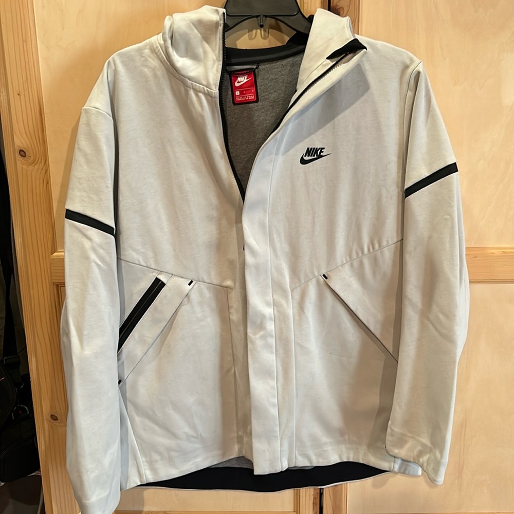 Nike Men’s Jacket with zipper pockets and hoodie.  Bone colored. Never worn.